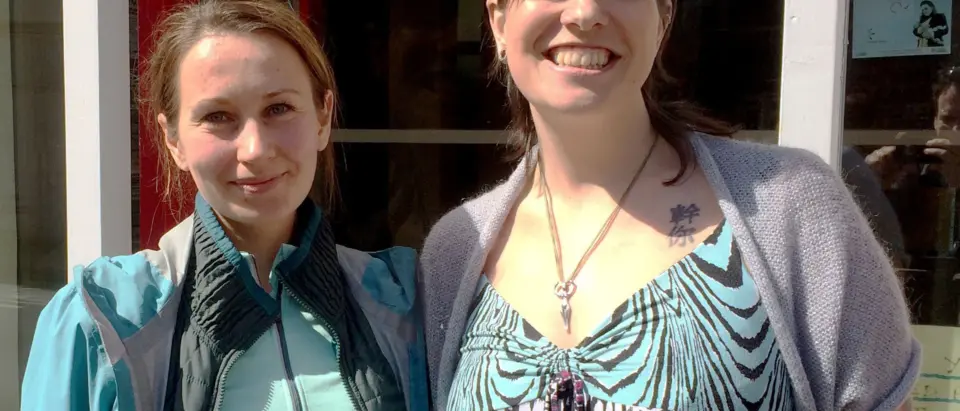 Two people smiling at the camera at SEND Project